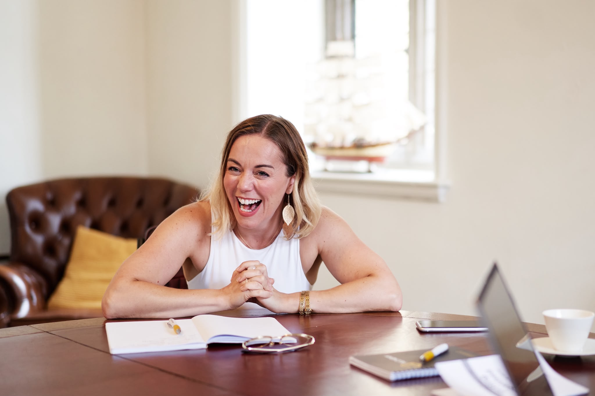 Sarah discussing work at a table